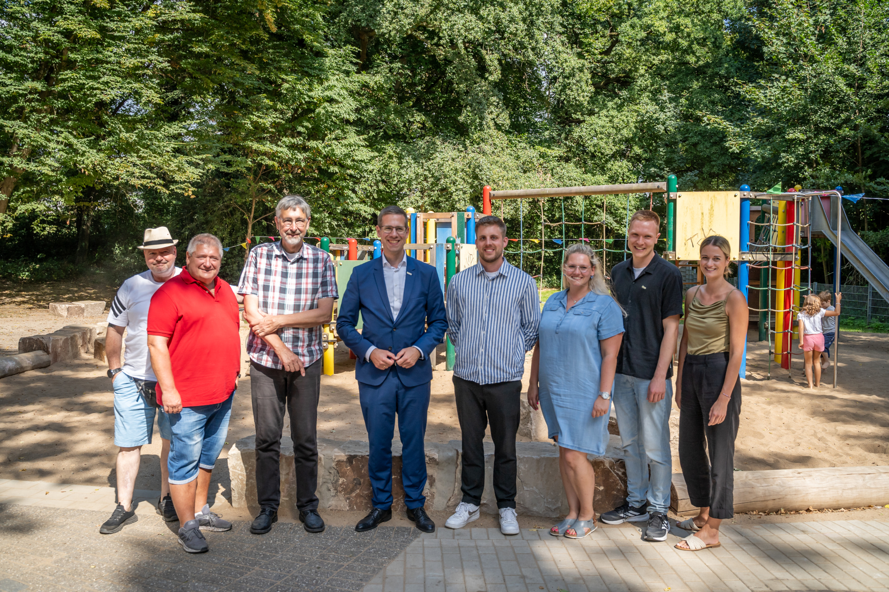 Spielplatzeröffnung Gretenberg Bürgermeister Christoph Schultz (4.v.l.) eröffnete gemeinsam mit den am Projekt beteiligten Personen und mehreren neugierigen Kindern den neugestalteten Spielplatz Gretenberg in Hochdahl.